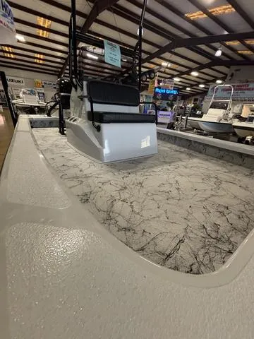 Slide: The Image of 2025 Majek 21 RFL boat with sleek interior design in a showroom setting. - 4