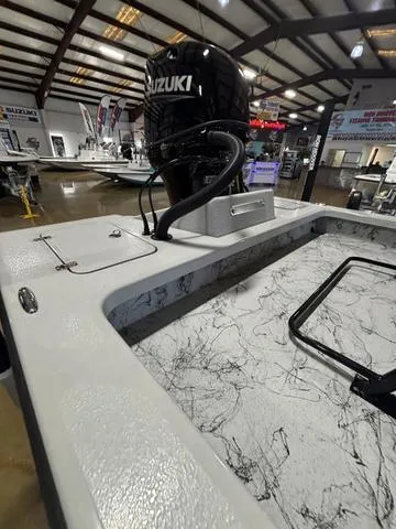 Slide: The Image of 2025 Majek 21 RFL boat with Suzuki engine in showroom setting. - 6