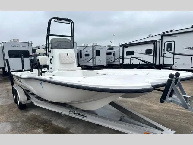 Slide: The Image of 2023 Catalyst Boat Works 2200 CAT on trailer, parked near RVs, overcast sky. - 1