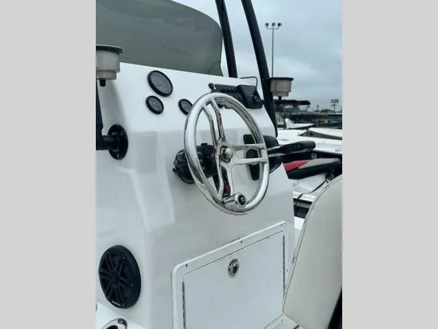 Slide: The Image of 2023 Catalyst Boat Works 2200 CAT dashboard with steering wheel and controls. - 11