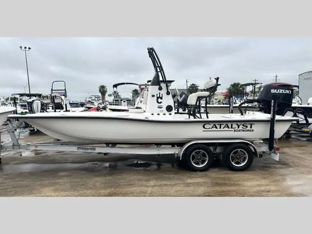 Slide: The Image of 2023 Catalyst Boat Works 2200 CAT on trailer, displayed outdoors with overcast sky. - 7