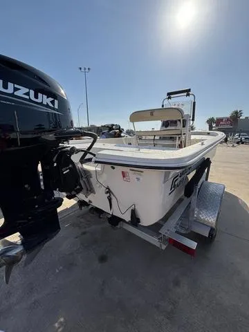 Slide: The Image of 2024 Carolina Skiff E18 JVX CC boat with Suzuki outboard motor on trailer. - 3