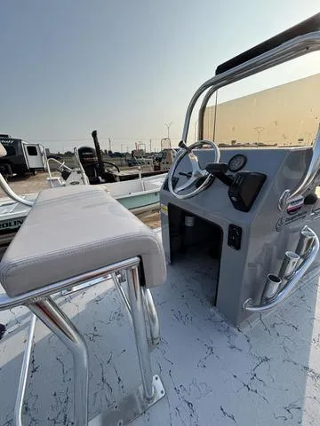 Slide: The Image of 2024 Cougar Marine Payton Scooter boat interior with steering console and seating. - 6