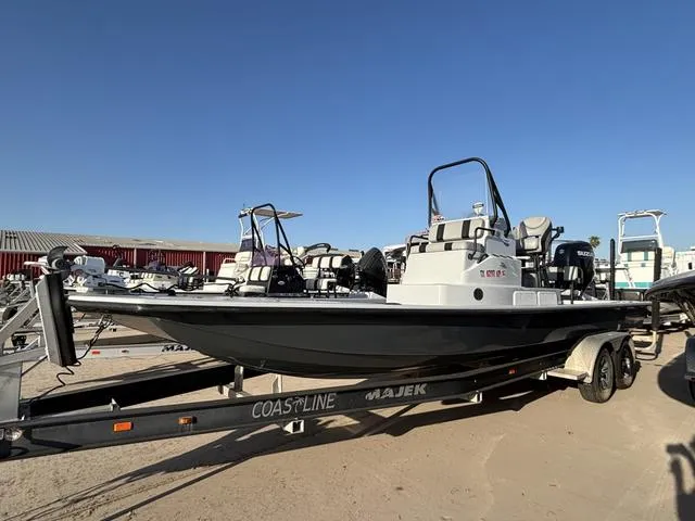 Slide: The Image of 2022 Majek 25 ILLUSION boat on trailer under clear blue sky. - 1