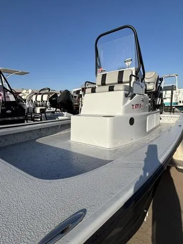 Slide: The Image of 2022 Majek 25 ILLUSION boat with center console, docked under clear blue sky. - 3