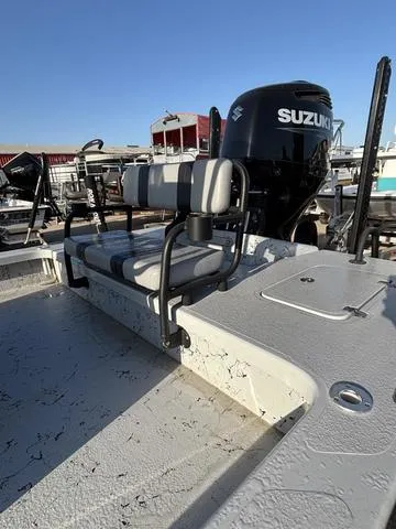 Slide: The Image of 2022 Majek 25 ILLUSION boat with Suzuki engine, featuring a striped bench seat. - 4