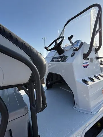 Slide: The Image of 2022 Majek 25 ILLUSION boat console and seating, featuring sleek design and modern controls. - 9