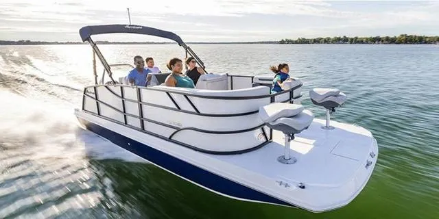 Slide: The Image of 2025 Hurricane FD2260REF boat cruising on a lake with passengers enjoying the ride. - 1