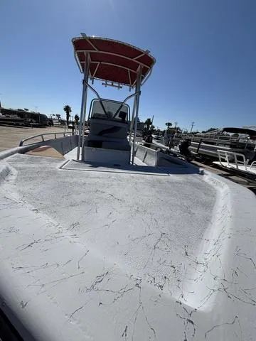 Slide: The Image of 2004 Blue Wave 22STL boat with T-top, docked under clear blue sky. - 3