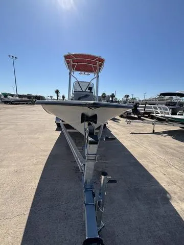 Slide: The Image of 2004 Blue Wave 22STL boat on trailer under clear blue sky. - 4