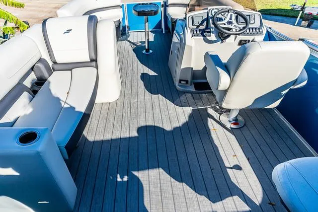 Slide: The Image of 2025 Starcraft EX20FD boat interior with modern seating and steering console. - 13