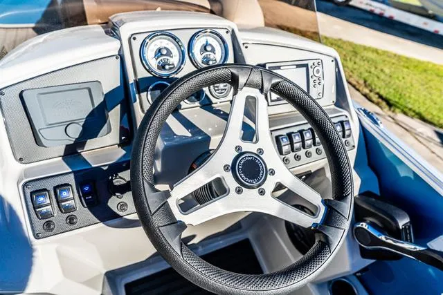 Slide: The Image of 2025 Starcraft EX20FD boat dashboard with steering wheel and control panel. - 2