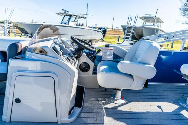 Slide: The Image of 2025 Starcraft EX20FD boat interior with steering console and captain's chair. - 3