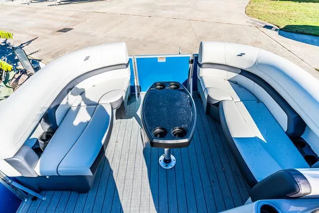 Slide: The Image of 2025 Starcraft EX20FD boat interior with spacious seating and central table. - 4
