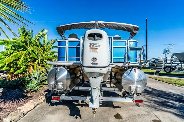 Slide: The Image of 2025 Starcraft EX20FD pontoon boat with 115 HP engine, parked outdoors. - 8