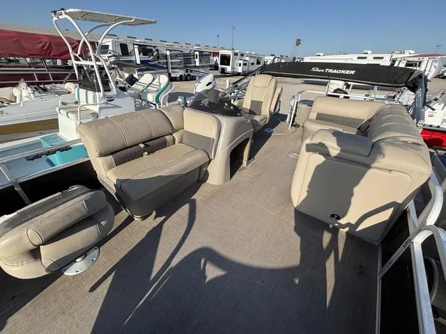 Slide: The Image of 2021 Sun Tracker FISH BARGE 20 pontoon boat with beige seating and spacious deck. - 4