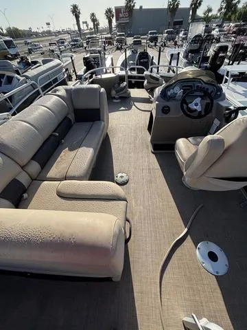 Slide: The Image of 2021 Sun Tracker FISH BARGE 20 pontoon boat interior with seating and steering console. - 6