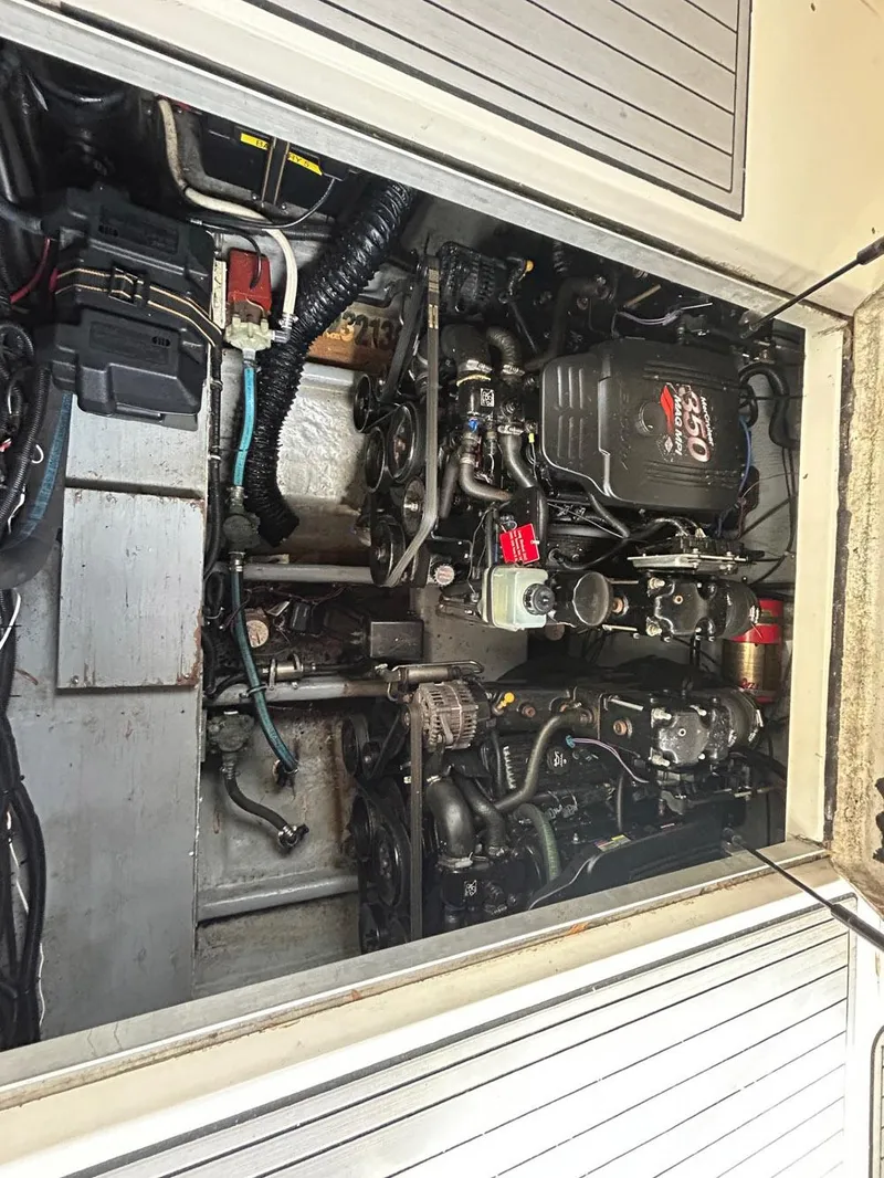 Slide: The Image of Engine compartment of a 2003 Monterey 302 Cruiser boat, showcasing mechanical components. - 12
