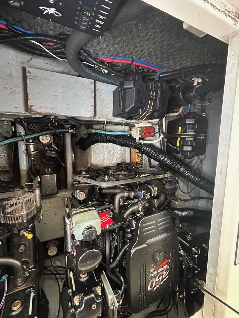 Slide: The Image of Engine compartment of a 2003 Monterey 302 Cruiser boat, showcasing mechanical components. - 13