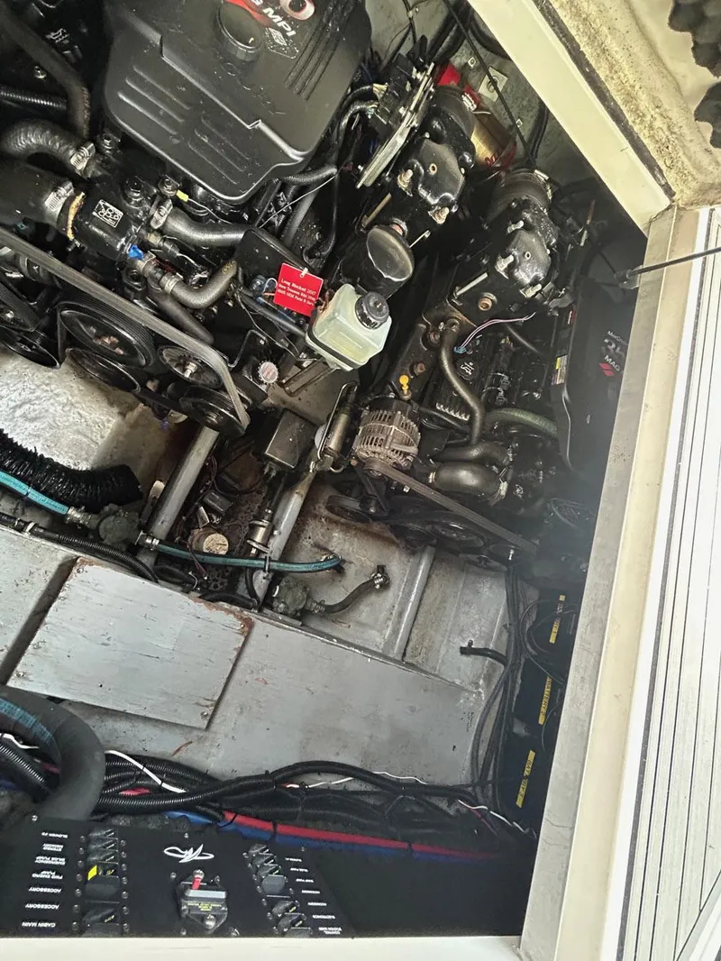 Slide: The Image of Engine compartment of a 2003 Monterey 302 Cruiser boat, showcasing mechanical components. - 14