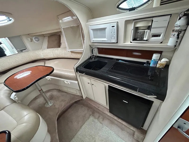 Slide: The Image of Interior of a 2003 Monterey 302 Cruiser with kitchenette and seating area. - 17
