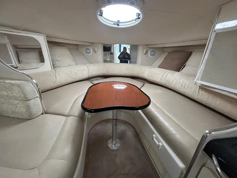 Slide: The Image of Interior of 2003 Monterey 302 Cruiser with beige seating and wooden table. - 18