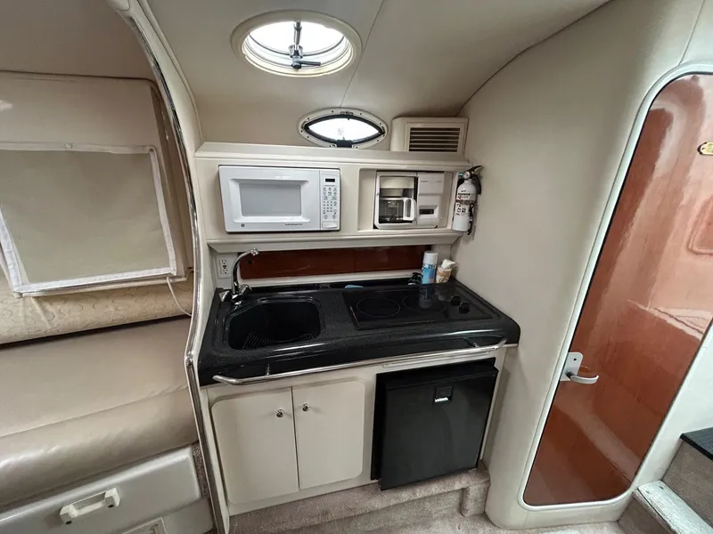 Slide: The Image of 2003 Monterey 302 Cruiser kitchen with microwave, sink, and mini fridge. - 20