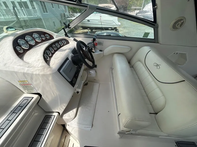 Slide: The Image of 2003 Monterey 302 Cruiser cockpit with white leather seating and instrument panel. - 9