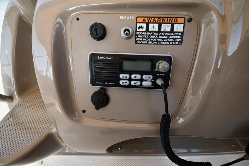 Slide: The Image of Control panel of a 2000 Maxum 2700 SCR boat with warning label and radio. - 14