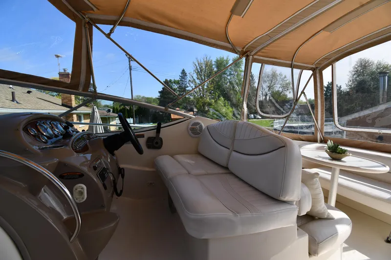 Slide: The Image of 2000 Maxum 2700 SCR boat interior with beige seating and steering wheel. - 16