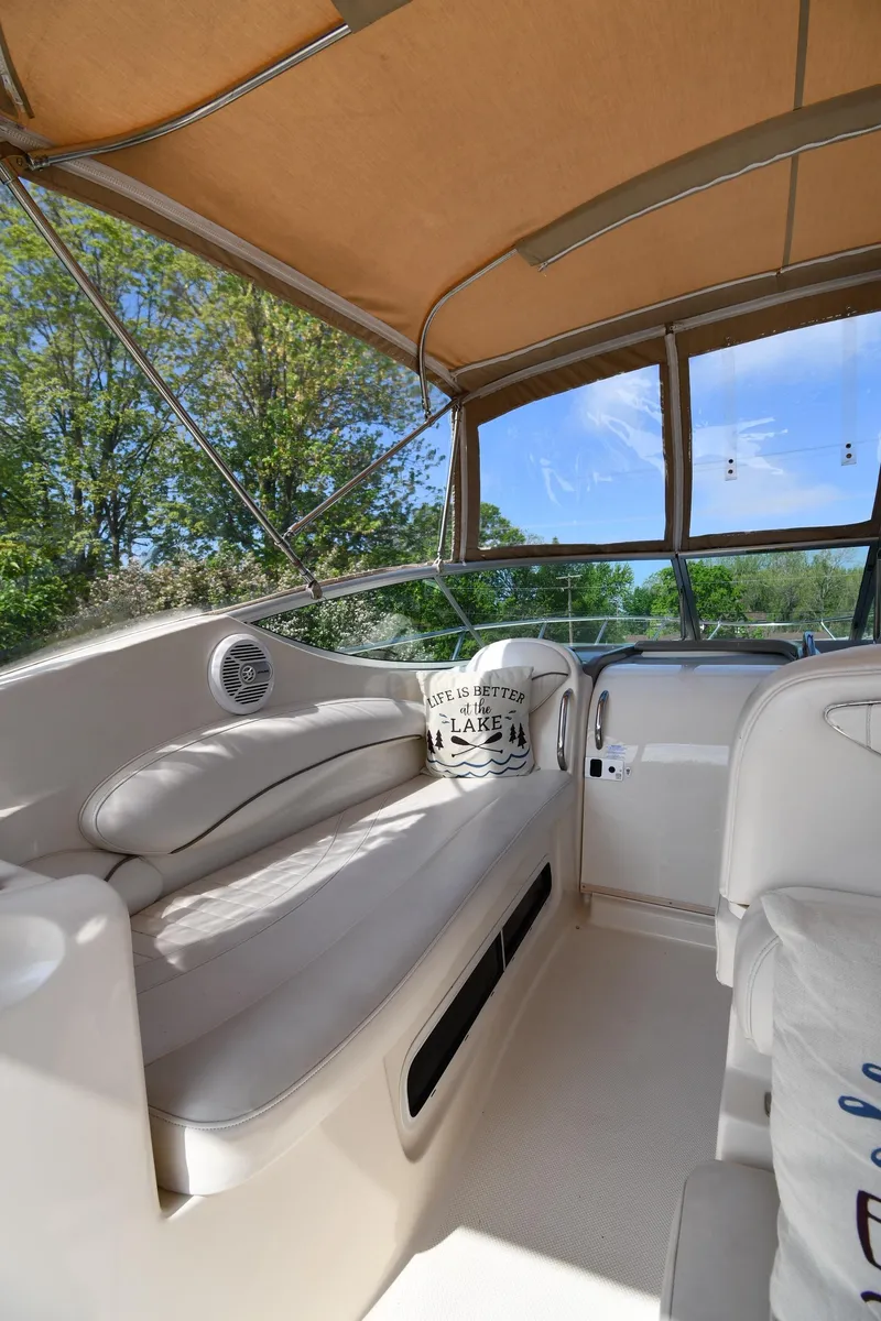 Slide: The Image of 2000 Maxum 2700 SCR boat interior with cushioned seating and canopy. - 18