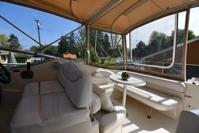 Slide: The Image of Interior of 2000 Maxum 2700 SCR boat with beige seating and table. - 24