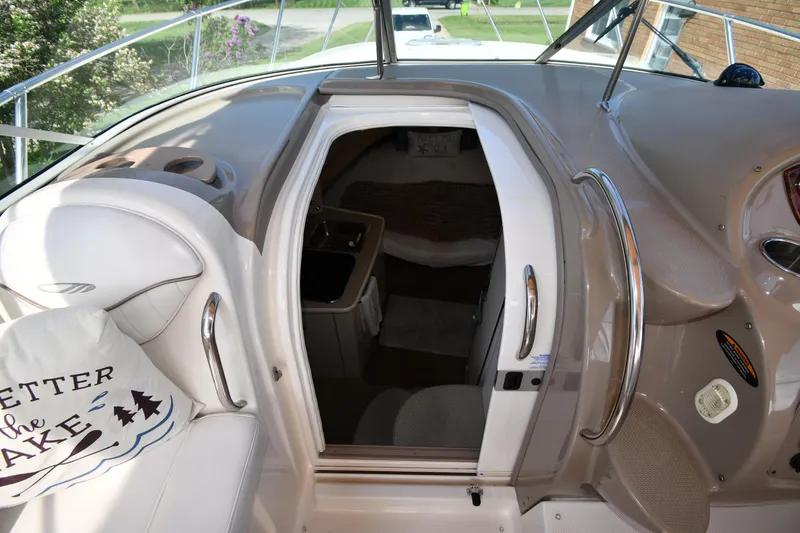 Slide: The Image of 2000 Maxum 2700 SCR boat interior with cabin entrance and seating area. - 25