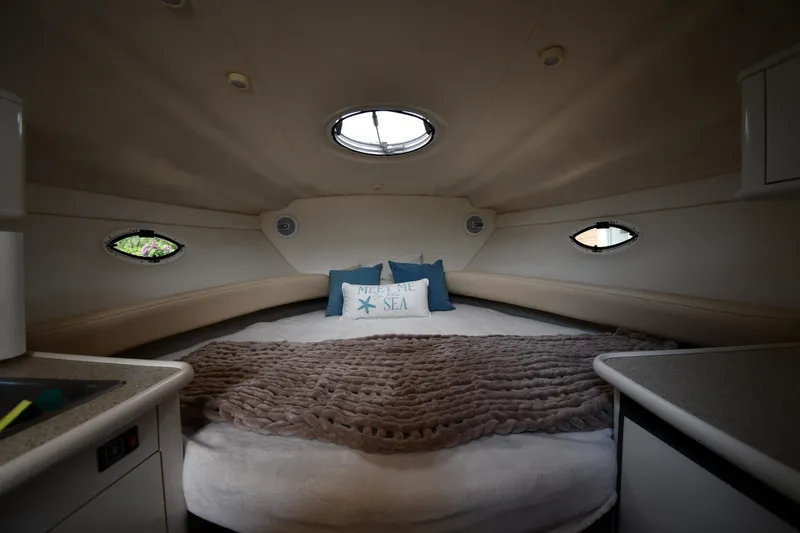 Slide: The Image of Cozy cabin interior of 2000 Maxum 2700 SCR boat with plush bedding and porthole windows. - 26