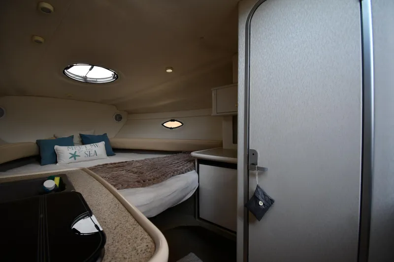 Slide: The Image of Interior cabin of 2000 Maxum 2700 SCR boat with cozy bed and porthole windows. - 29