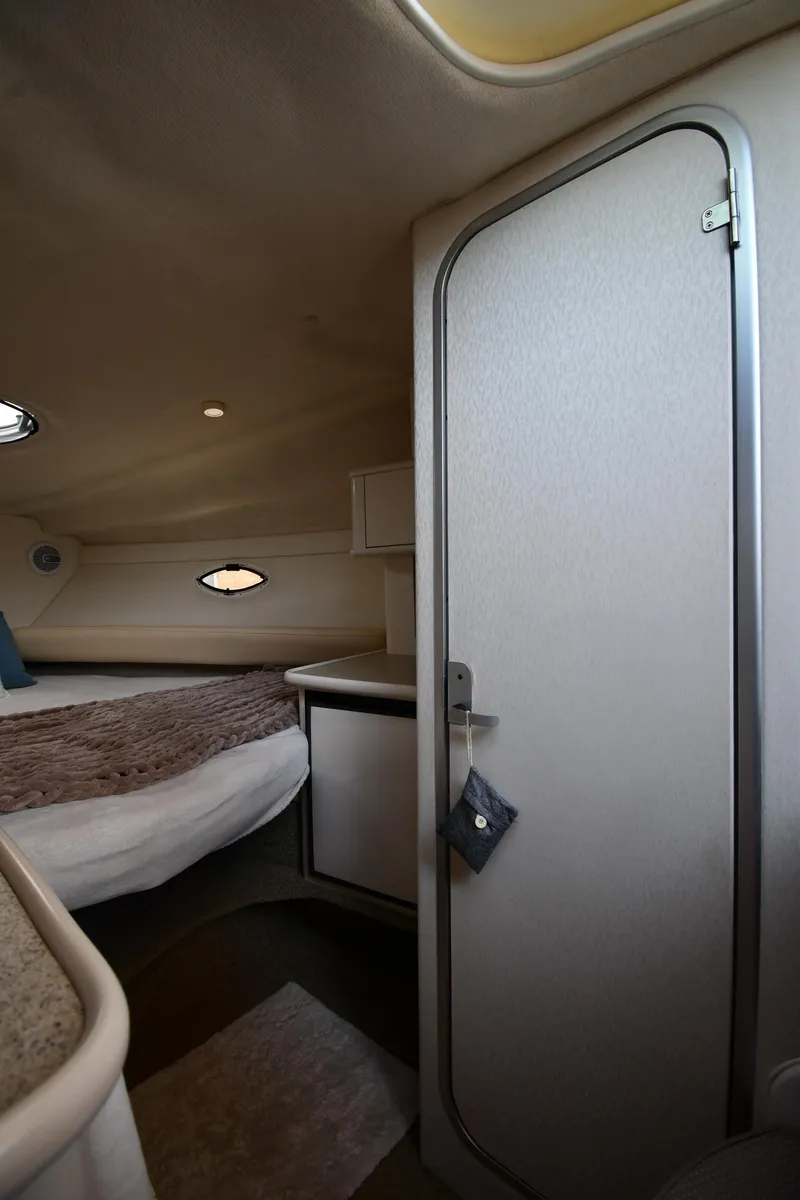 Slide: The Image of Interior cabin of 2000 Maxum 2700 SCR boat, featuring a cozy bed and compact design. - 30