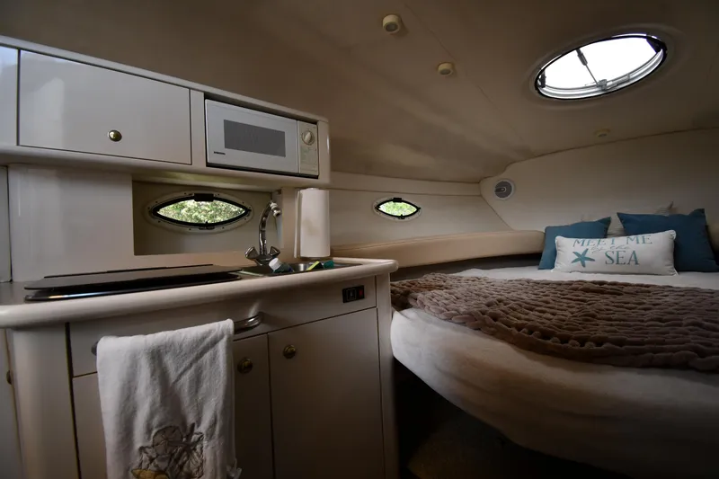 Slide: The Image of Interior of 2000 Maxum 2700 SCR boat with kitchenette and cozy sleeping area. - 31