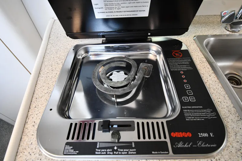 Slide: The Image of Stove in 2000 Maxum 2700 SCR boat kitchen, featuring an Origo alcohol-electric burner. - 37