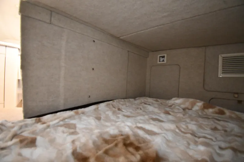 Slide: The Image of Interior cabin of 2000 Maxum 2700 SCR boat with cozy sleeping area. - 43