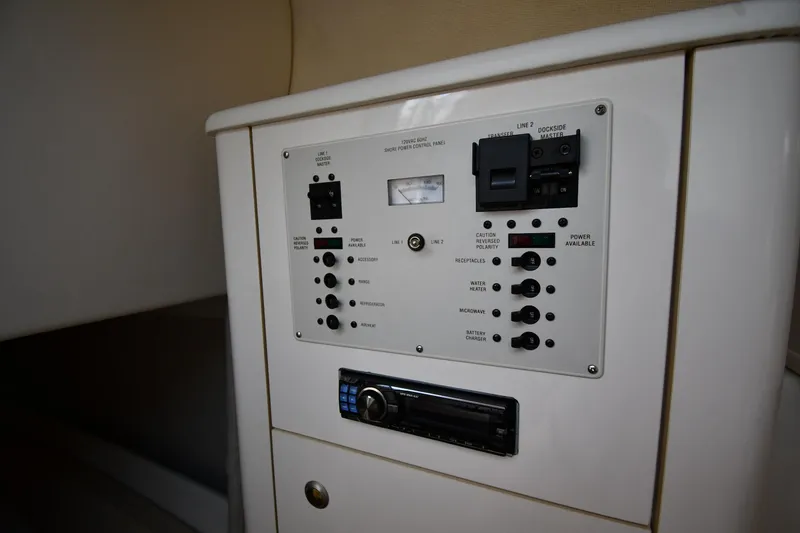 Slide: The Image of Control panel of 2000 Maxum 2700 SCR boat, featuring switches and audio system. - 44