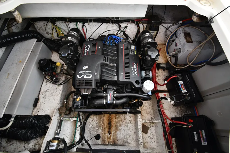 Slide: The Image of Engine compartment of a 2000 Maxum 2700 SCR boat, featuring a powerful V8 engine. - 46