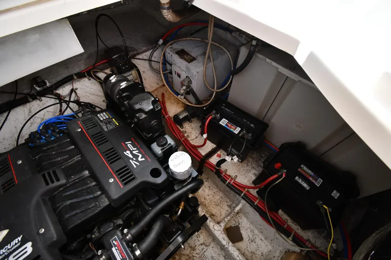 Slide: The Image of Engine compartment of a 2000 Maxum 2700 SCR boat, featuring Mercury engine and battery setup. - 48