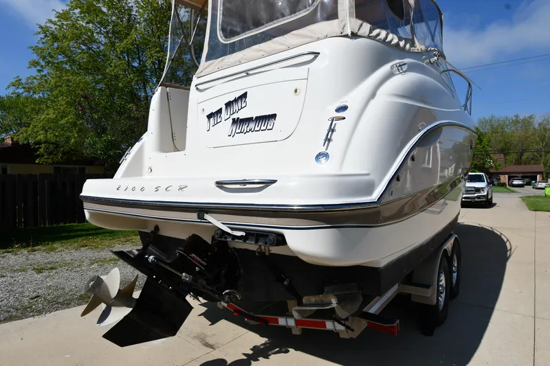 Slide: The Image of 2000 Maxum 2700 SCR boat on trailer, rear view, parked on driveway. - 5