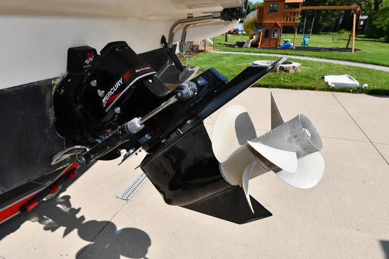 Slide: The Image of 2000 Maxum 2700 SCR boat with Mercury outdrive and propeller, parked on concrete driveway. - 7