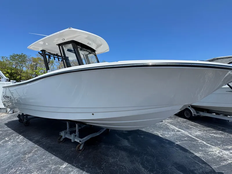The Image of 2025 Robalo R270 Center Console boat on display under clear blue sky. - 1