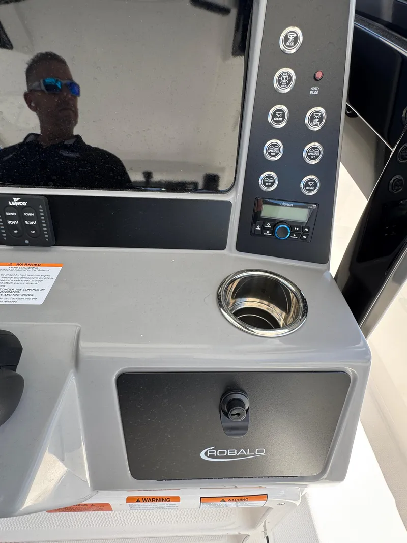Slide: The Image of 2025 Robalo R270 Center Console dashboard with controls and cup holder. - 14