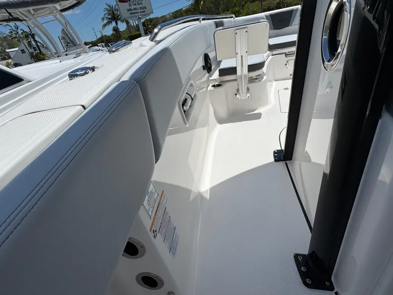 Slide: The Image of 2025 Robalo R270 Center Console boat interior, featuring sleek white seating and modern design elements. - 19