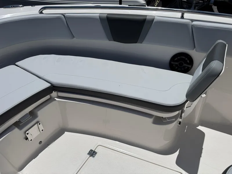 Slide: The Image of 2025 Robalo R270 Center Console boat seating area with cushioned bench and sleek design. - 22
