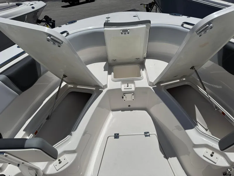 Slide: The Image of 2025 Robalo R270 Center Console boat with open storage compartments. - 24