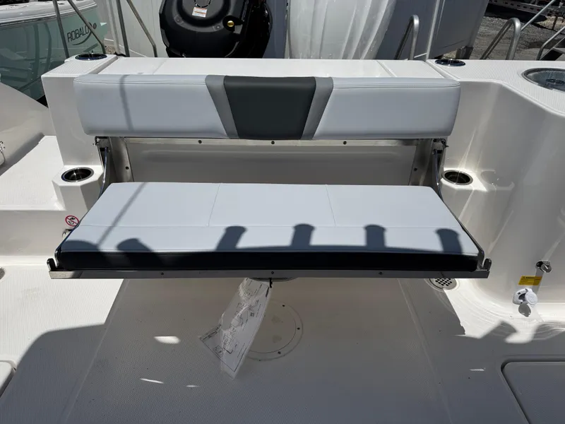Slide: The Image of 2025 Robalo R270 Center Console boat with foldable seating and modern design. - 7